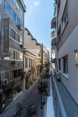 an empty street in a city with buildings at Central Calm Apartment in Athens