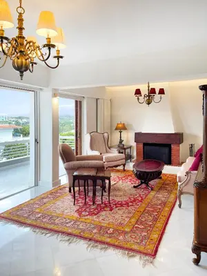 a living room with a couch and a fireplace at Blue Bay Vouliagmeni Luxury Apartment in Athens