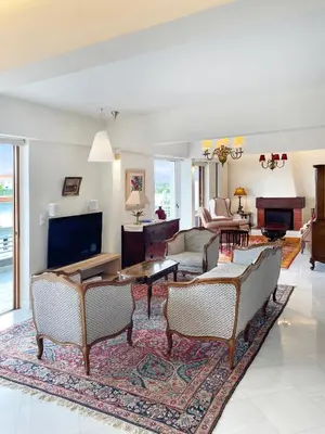 a living room with a couch and a table at Blue Bay Vouliagmeni Luxury Apartment in Athens
