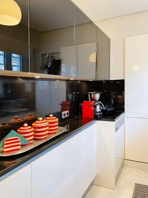 a kitchen with red plates on a counter at Blue Bay Vouliagmeni Luxury Apartment in Athens