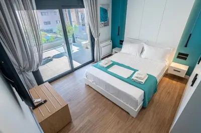 a small bedroom with a bed and a large window at A&N Athens Luxury Apartments - Akadimou in Athens