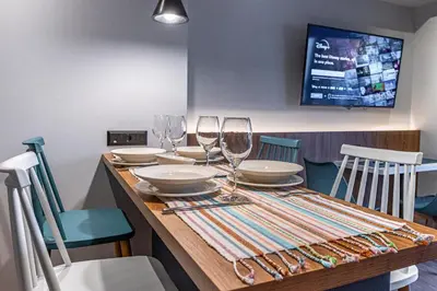 a wooden table with wine glasses and plates on it at A&N Athens Luxury Apartments - Akadimou in Athens