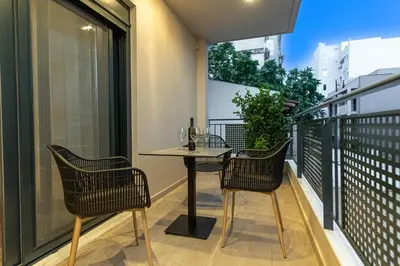 a small balcony with a table and two chairs at A&N Athens Luxury Apartments - Akadimou in Athens
