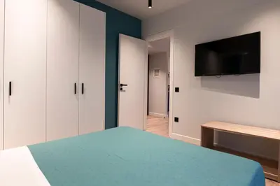 a bedroom with a bed and a flat screen tv at A&N Athens Luxury Apartments - Akadimou in Athens
