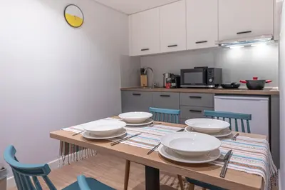 a kitchen with a wooden table with dishes on it at A&N Athens Luxury Apartments - Akadimou in Athens