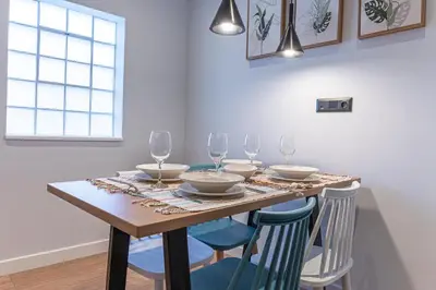 a dining room table with chairs and glasses on it at A&N Athens Luxury Apartments - Akadimou in Athens