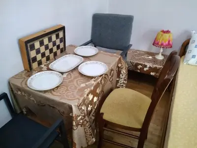 a table with plates on top of a table with chairs at flower apartment-Hilton-US embassy in Athens
