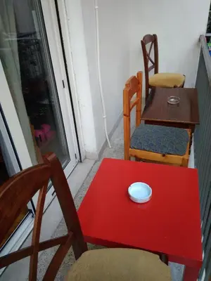 a table with two chairs and a red table with a mouse on it at flower apartment-Hilton-US embassy in Athens