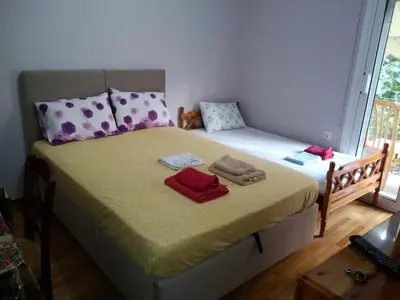 a bedroom with a bed with two towels on it at flower apartment-Hilton-US embassy in Athens