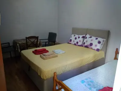 a small room with a bed and a table at flower apartment-Hilton-US embassy in Athens