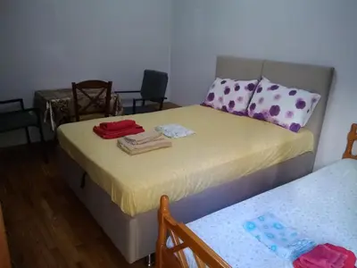 a bedroom with two beds and a table and chairs at flower apartment-Hilton-US embassy in Athens