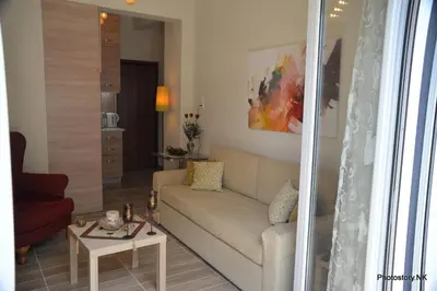 a living room with a couch and a table at kynosargous square's apartment in Athens