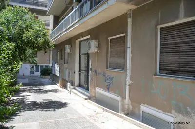 a building with graffiti on the side of it at kynosargous square's apartment in Athens