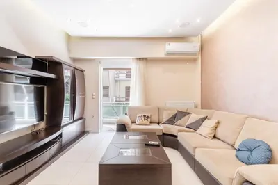 a living room with a couch and a flat screen tv at Filoxenia MG Projects Near Acropolis Veeikou in Athens