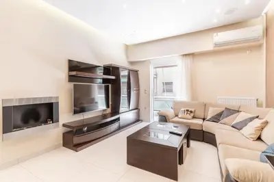 a living room with a couch and a flat screen tv at Filoxenia MG Projects Near Acropolis Veeikou in Athens
