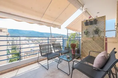 a balcony with chairs and a table with a view at Luxury Loft with a Balcony by CloudKeys in Athens