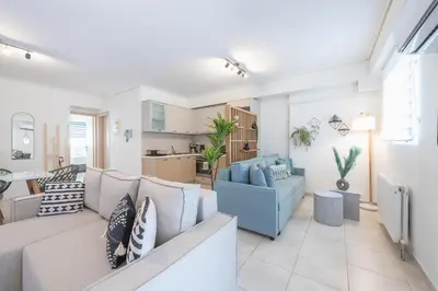 a living room with a couch and a table at Luxury Loft with a Balcony by CloudKeys in Athens