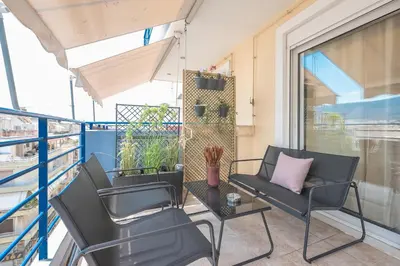 a balcony with two chairs and a table at Luxury Loft with a Balcony by CloudKeys in Athens