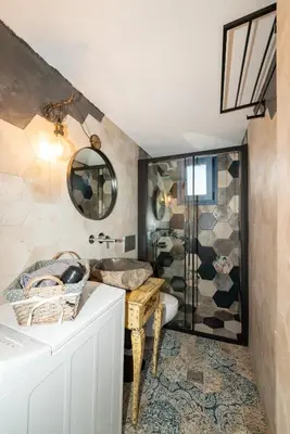 a bathroom with a sink and a shower at The Dona House in Vaia