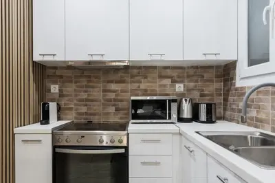 a kitchen with a sink and a stove top oven at Gorgeous 1BR Apartment in Kolonaki by UPSTREET in Athens