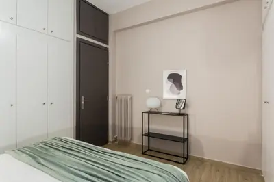 a bedroom with a bed and a black door at Gorgeous 1BR Apartment in Kolonaki by UPSTREET in Athens