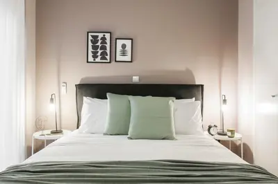 a bedroom with a large bed with white sheets and pillows at Gorgeous 1BR Apartment in Kolonaki by UPSTREET in Athens