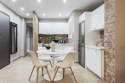 a kitchen with a white table and chairs at Gorgeous 1BR Apartment in Kolonaki by UPSTREET in Athens