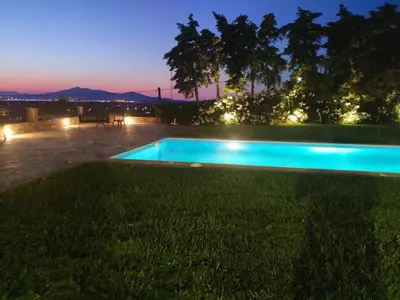 a swimming pool in a yard at night at Ellie's StoneHouse Gianapa, Porto Rafti, Greece, 190 03, GR in Porto Rafti