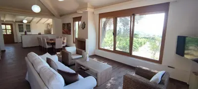 a living room with white furniture and a large window at Ellie's StoneHouse Gianapa, Porto Rafti, Greece, 190 03, GR in Porto Rafti