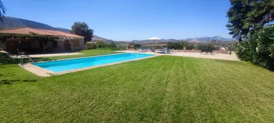 a large yard with a swimming pool and a house at Ellie's StoneHouse Gianapa, Porto Rafti, Greece, 190 03, GR in Porto Rafti