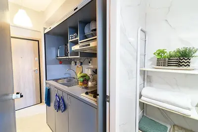 a small kitchen with blue walls and a counter at jack daniel's appartment in Athens