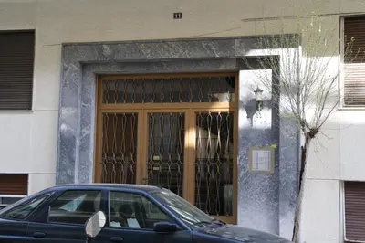 a car parked in front of a building with a door at Work or Vacation in shared apartment in Athens