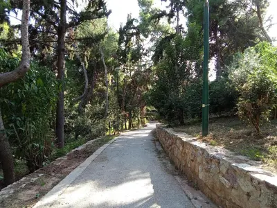 a road with a green pole on the side at Work or Vacation in shared apartment in Athens