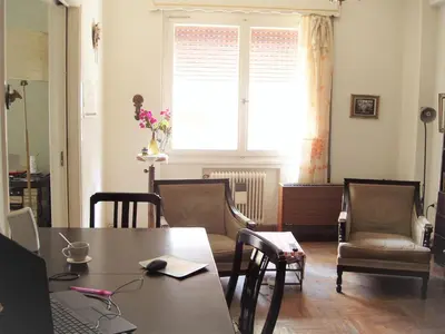 a dining room with a table and chairs and a window at Work or Vacation in shared apartment in Athens