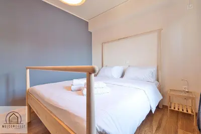 a bedroom with a large bed with white sheets at Bright & Restful! in Athens