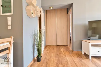 a hallway with a desk and a tv in a room at Bright & Restful! in Athens