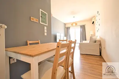 a dining room and living room with a table and chairs at Bright & Restful! in Athens