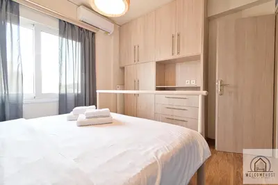 a bedroom with a large white bed and a window at Bright & Restful! in Athens
