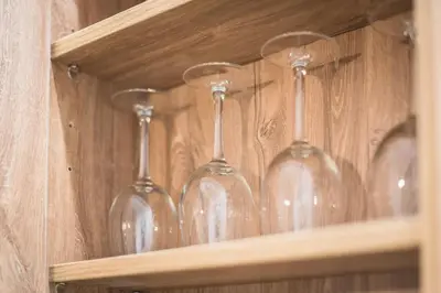 a row of wine glasses sitting on a shelf at Stylish 1BR apartment in the heart of Koukaki in Athens