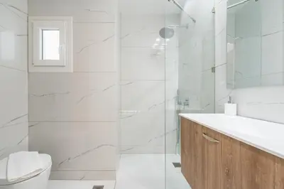 a bathroom with a shower and a toilet and a sink at Stylish 1BR apartment in the heart of Koukaki in Athens