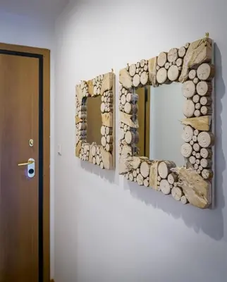 a driftwood mirror on a wall next to a door at Lush Sapphire apt steps from Acropolis & Plaka! in Athens