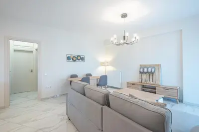 a living room with a couch and a table at Newly renovated apt in the heart of Kerameikos in Athens