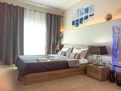 a bedroom with a bed and a large window at Pipinou Studio in Athens