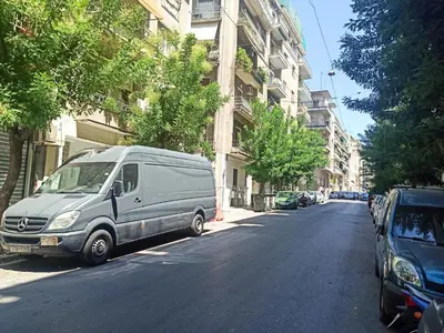 a van parked on the side of a city street at Pipinou Studio in Athens