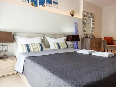 a bedroom with a large bed with two towels on it at Pipinou Studio in Athens