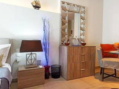 a living room with a dresser and a mirror at Pipinou Studio in Athens