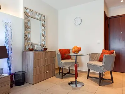 a room with a table and two chairs and a mirror at Pipinou Studio in Athens