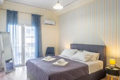 a bedroom with a bed with two towels on it at 2 Bedroom condo with dream balcony in Athens