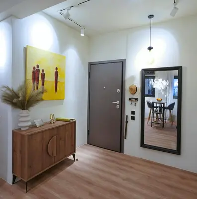 a living room with a door and a painting on the wall at P Faliro Riviera Suite in Athens