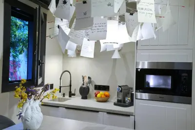 a kitchen with papers hanging over a sink and a counter at P Faliro Riviera Suite in Athens